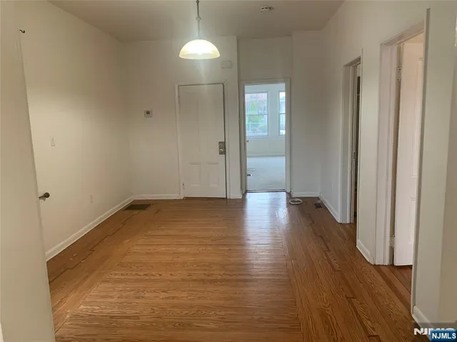 a view of a room with wooden floor