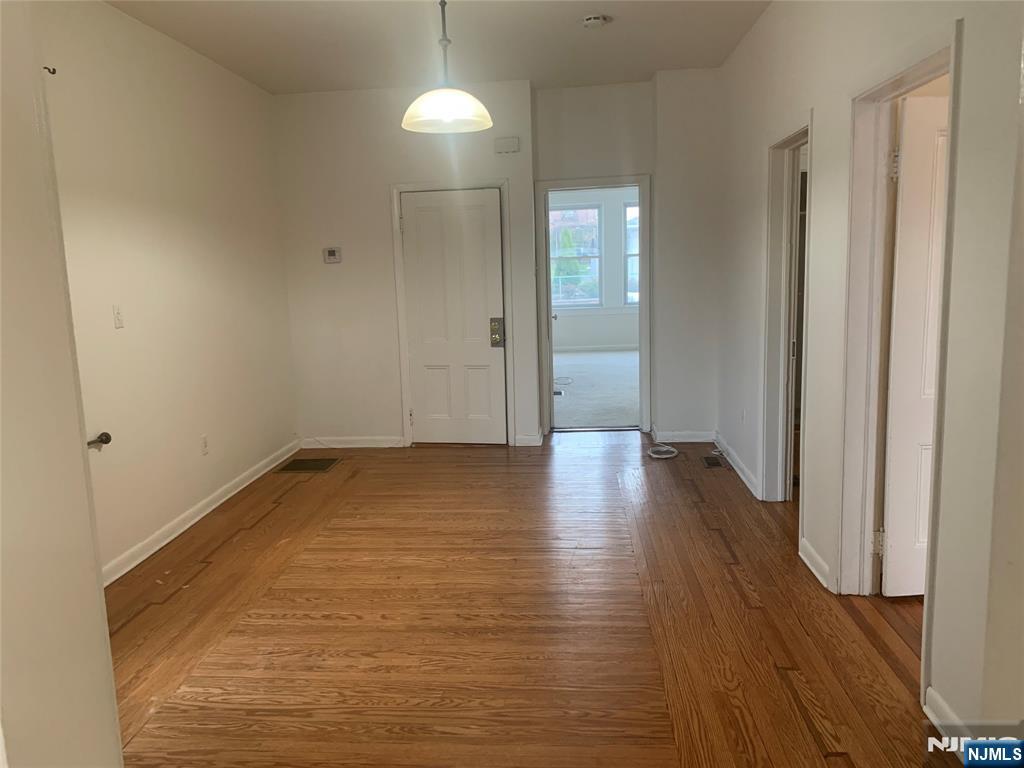 10 Exchange Place, Unit 1 Clifton, NJ 07011 - Photo 2 of 19 a view of a room with wooden floor