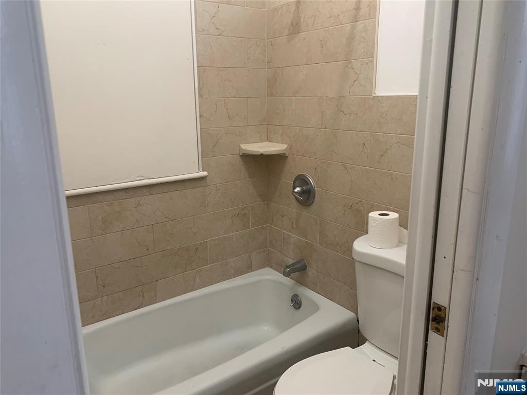10 Exchange Place, Unit 1 Clifton, NJ 07011 - Photo 9 of 19 a bathroom with a bathtub and toilet