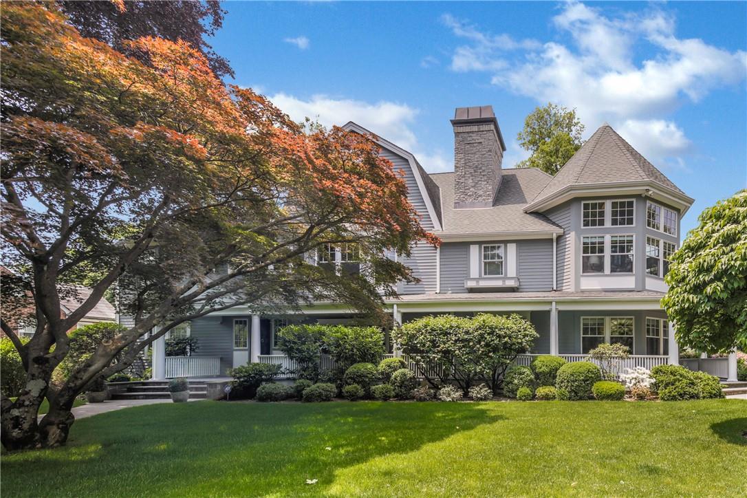 a front view of a house with a yard and trees