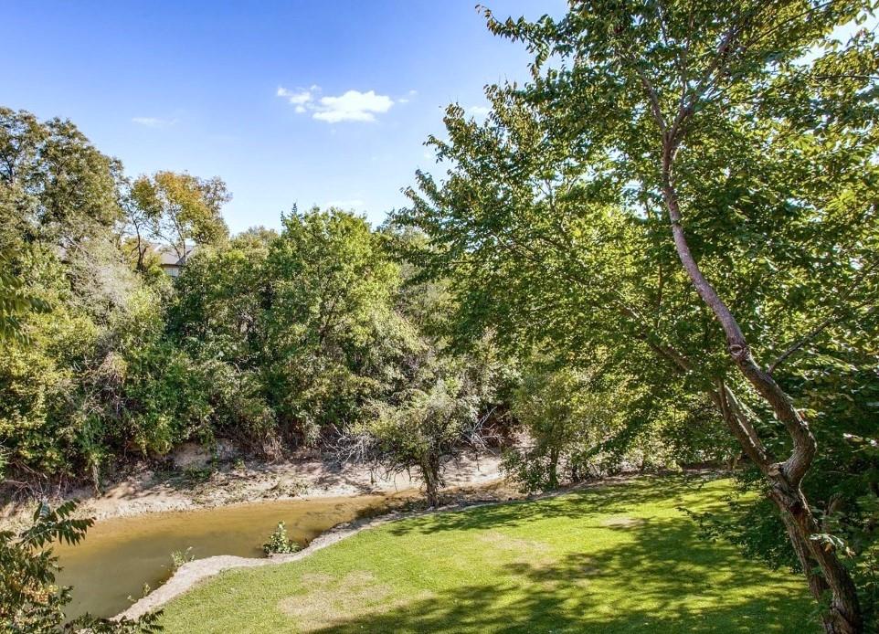 7340 Skillman Street, Unit 1203 Dallas, TX 75231 - Photo 12 of 12 a view of a large tree with lawn chairs under an umbrella