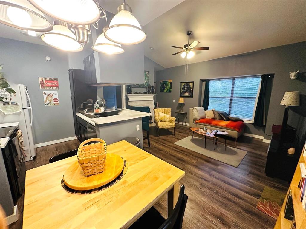 7340 Skillman Street, Unit 1203 Dallas, TX 75231 - Photo 2 of 12 a living room with dining table and couches with kitchen view