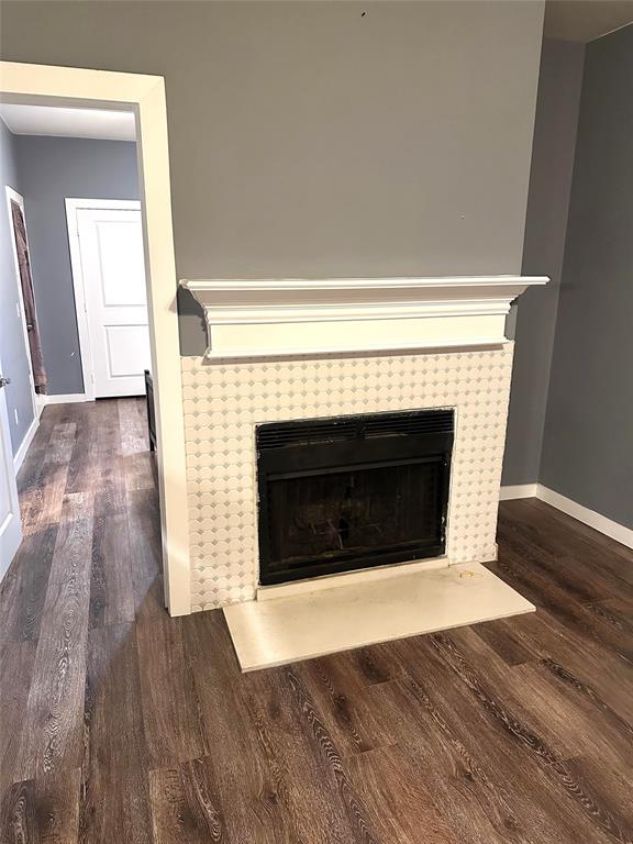 7340 Skillman Street, Unit 1203 Dallas, TX 75231 - Photo 3 of 12 a living room with a fireplace and wooden floor