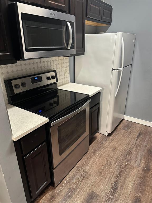 7340 Skillman Street, Unit 1203 Dallas, TX 75231 - Photo 4 of 12 a kitchen with a stove microwave and refrigerator