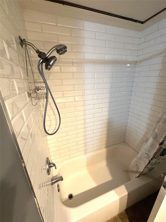 7340 Skillman Street, Unit 1203 Dallas, TX 75231 - Photo 6 of 12 a bathroom with a shower and a bathtub