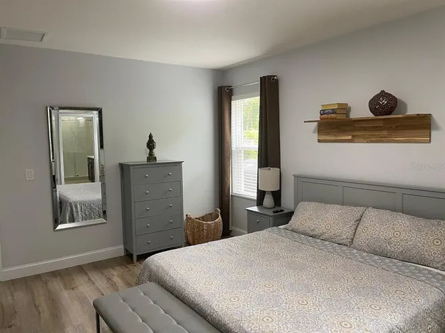 a bedroom with a bed and a dresser