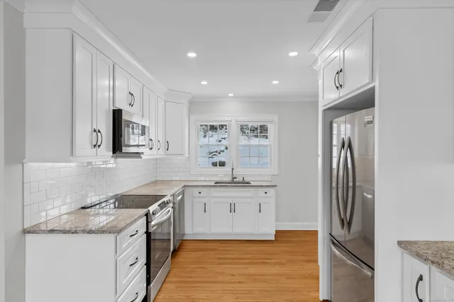 a kitchen with a sink stove and refrigerator