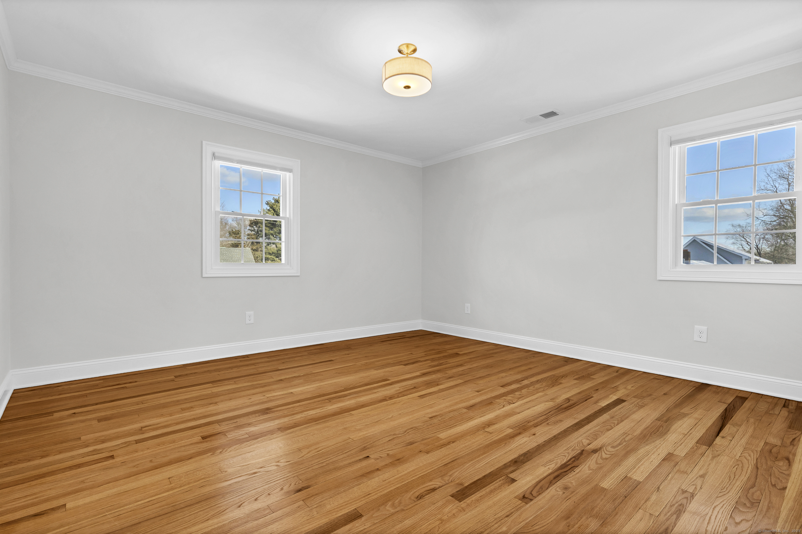 122 North Street, Unit 4 Guilford, CT 06437 - Photo 17 of 22 a view of empty room with wooden floor and fan