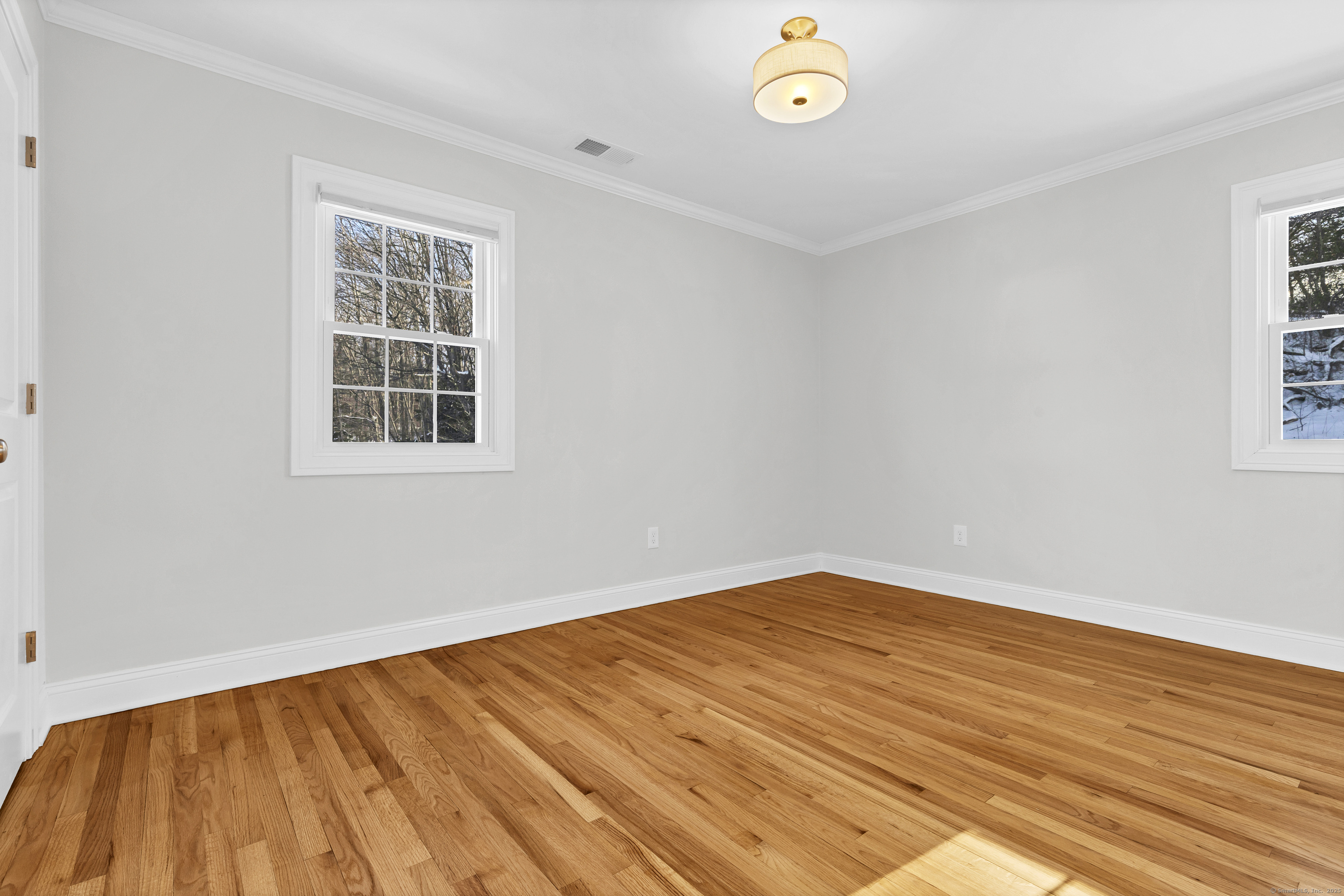 122 North Street, Unit 4 Guilford, CT 06437 - Photo 19 of 22 an empty room with wooden floor and windows