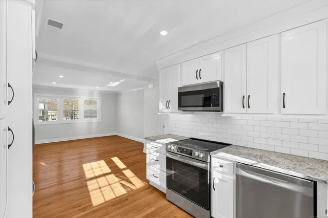 a kitchen with granite countertop a stove and a sink