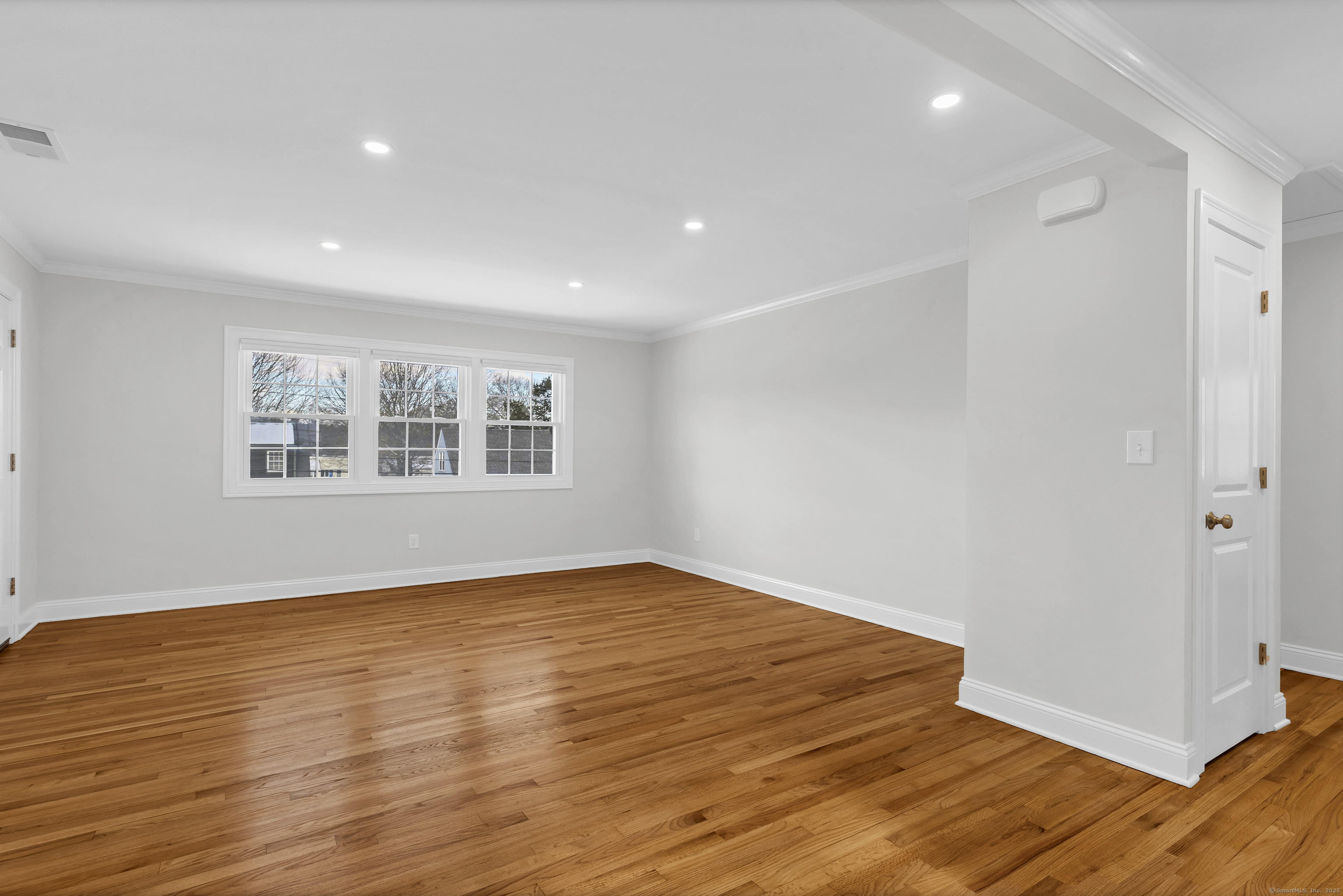 122 North Street, Unit 4 Guilford, CT 06437 - Photo 10 of 22 a view of an empty room with wooden floor and a window