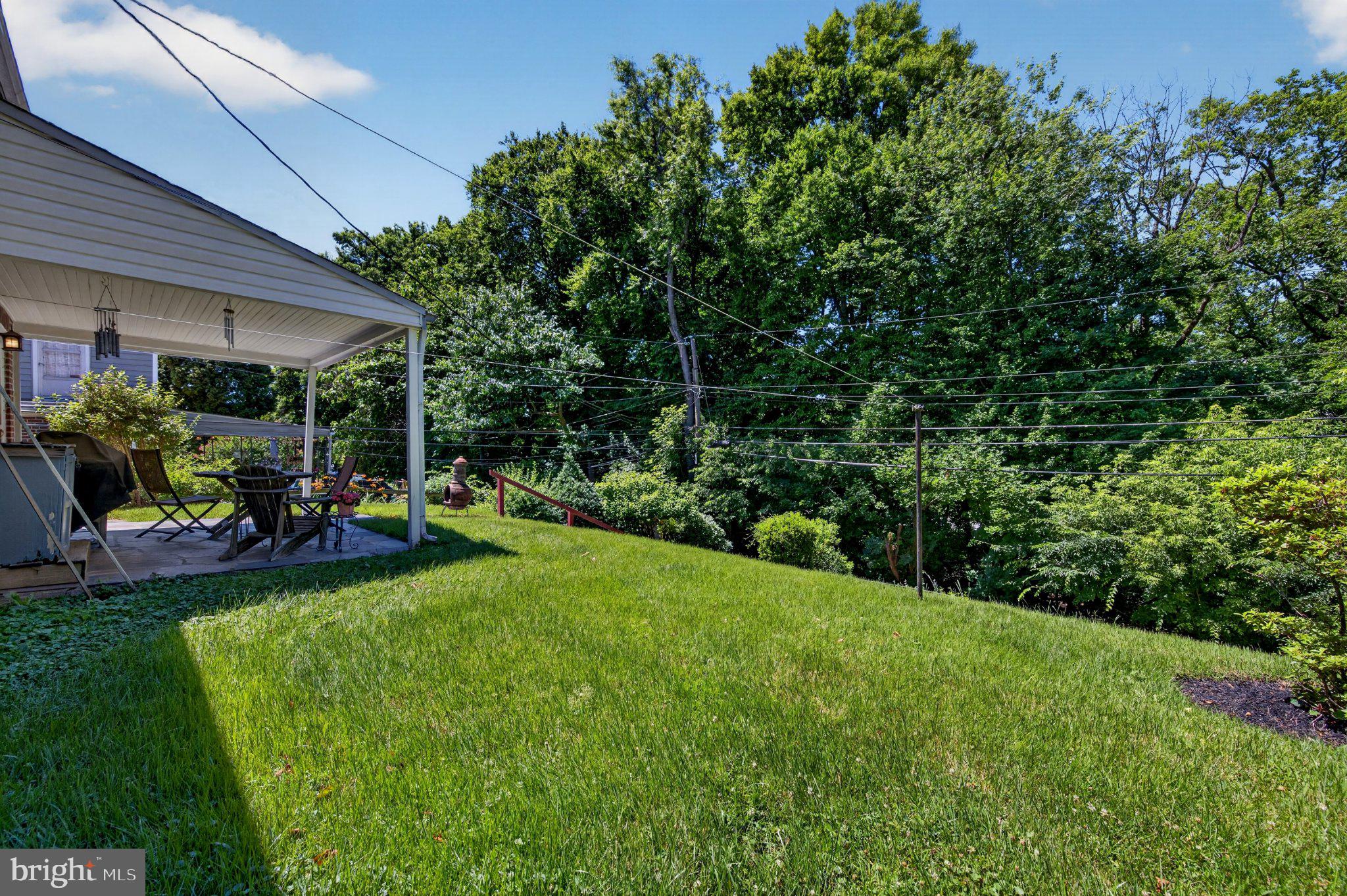 128 Boncouer Road Cheltenham, PA 19012 - Photo 30 of 31 Lush green yard with serene backdrop.
