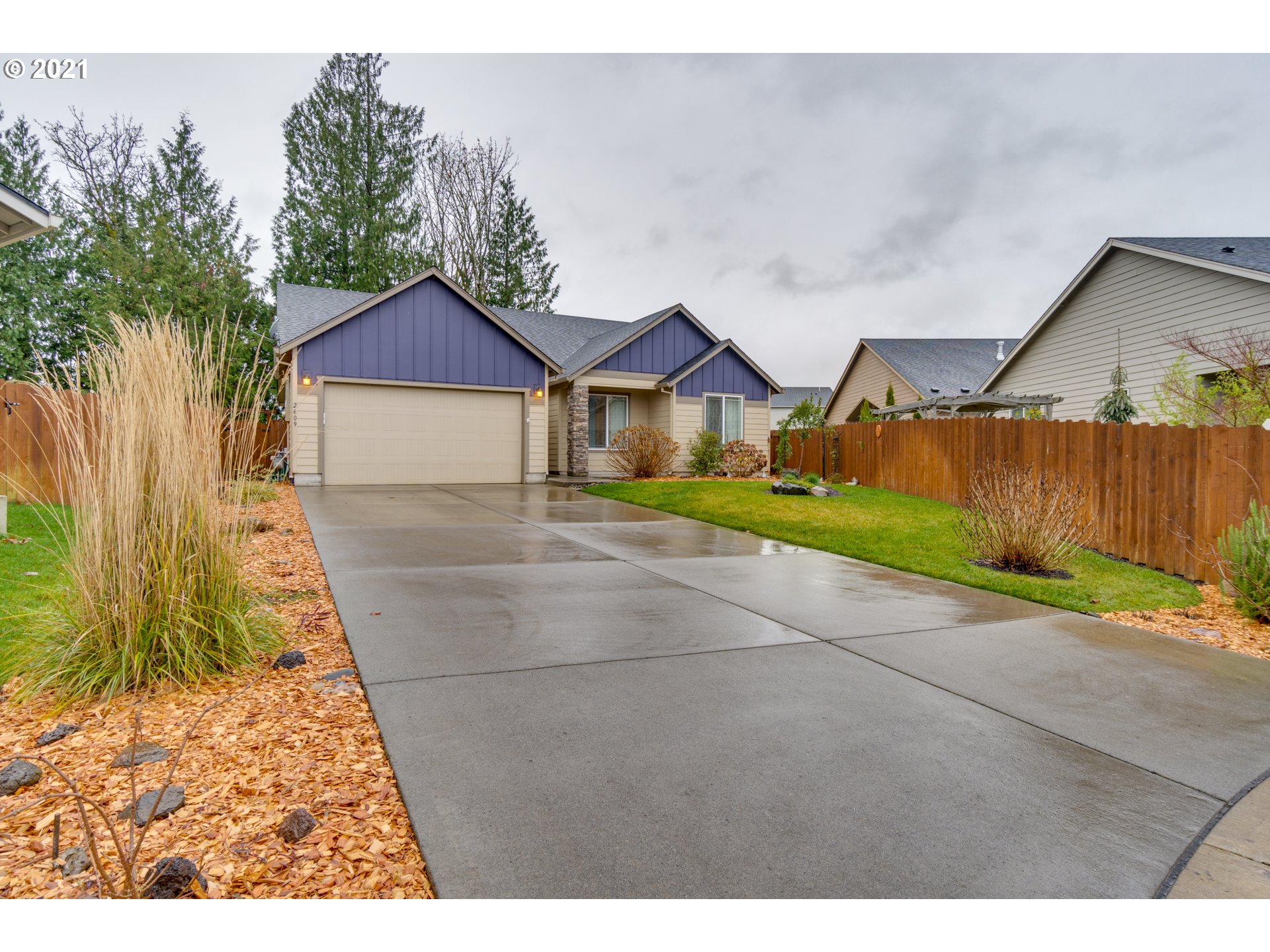 2609 South 18th Court Ridgefield, WA 98642 - Photo 1 of 26 a front view of a house with a yard and garage