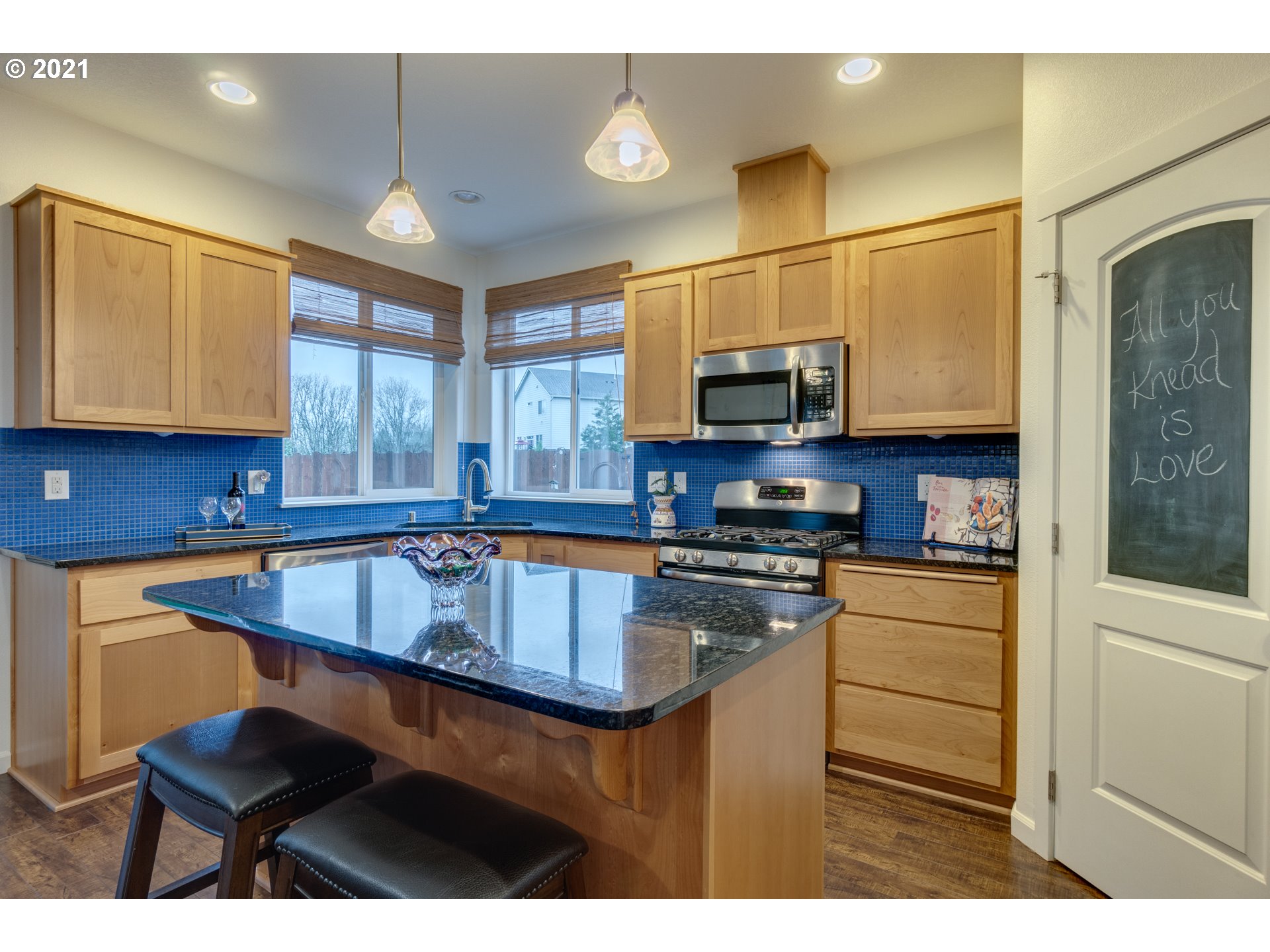 2609 South 18th Court Ridgefield, WA 98642 - Photo 10 of 26 a kitchen with stainless steel appliances granite countertop a sink a stove and a microwave