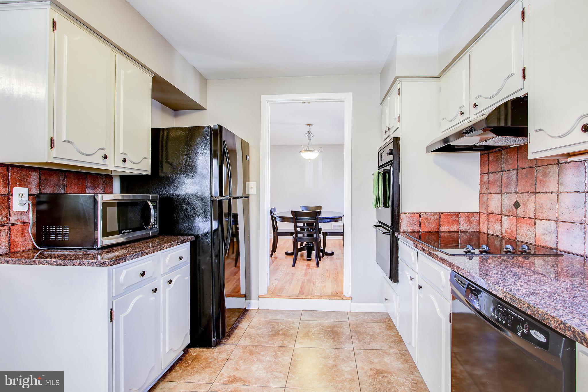 4805 Rim Rock Road Rockville, MD 20853 - Photo 12 of 31 Table Space Kitchen With Granite Counters