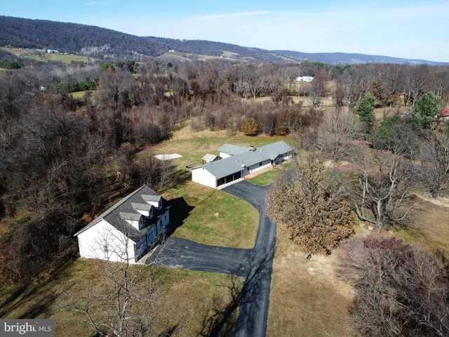 a view of a big yard with a house in the background