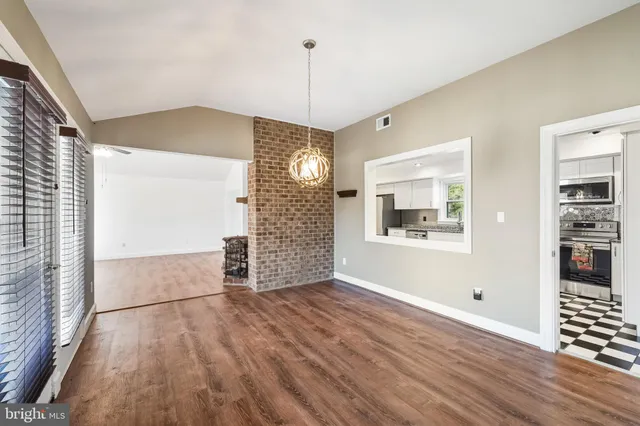 a view of a room with wooden floor and window