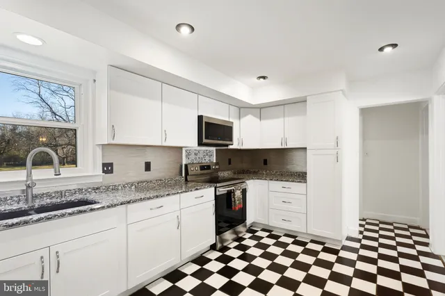 a view of a yard with large trees