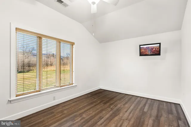 a view of a fire pit with plants and water view