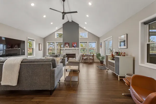 a living room with fireplace furniture and a wooden floor