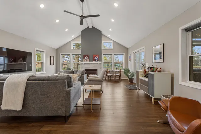 a living room with fireplace furniture and a wooden floor