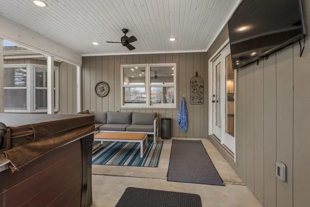 a view of a hallway with furniture and window