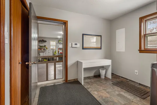 a view of a room that has a bench and a table in it