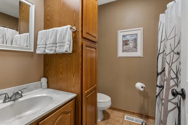 a bathroom with a sink mirror vanity and toilet