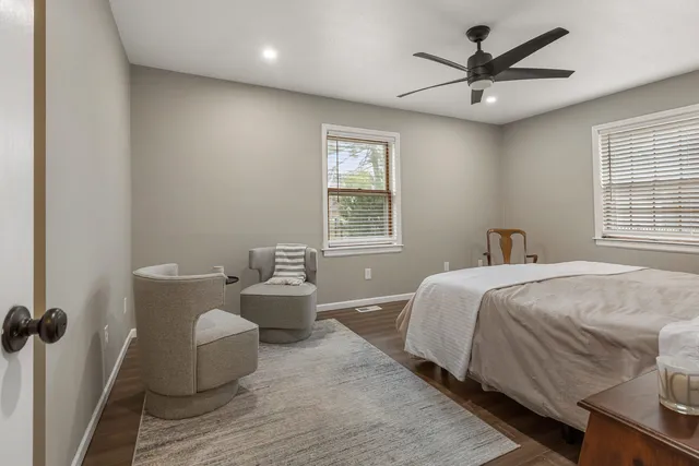 a spacious bedroom with a bed and a window