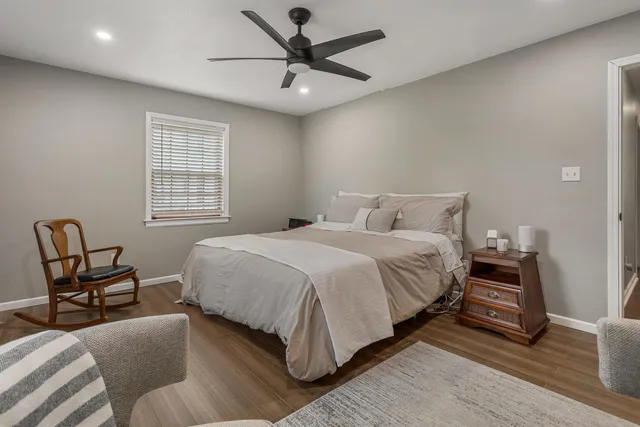 a bedroom with a bed chair and window