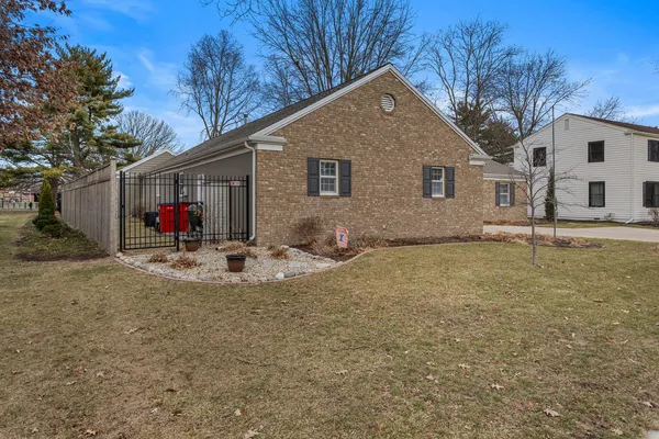 a view of a house with backyard and trees