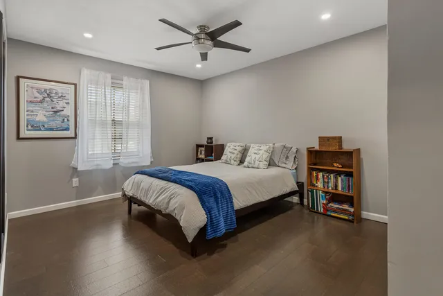 a bedroom with a bed and a book shelf