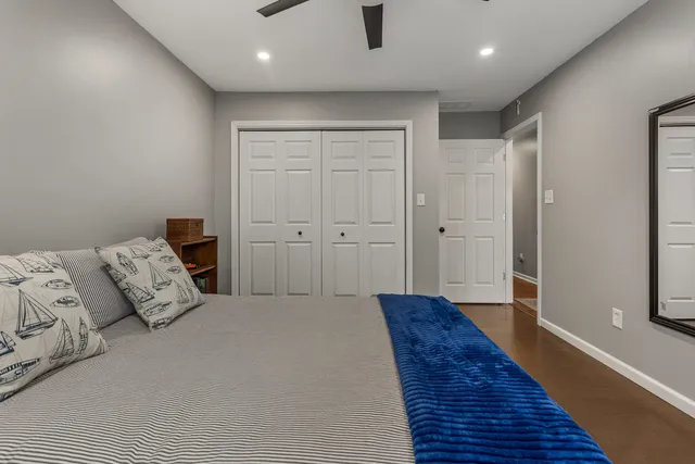 a bedroom with a bed and wooden floor