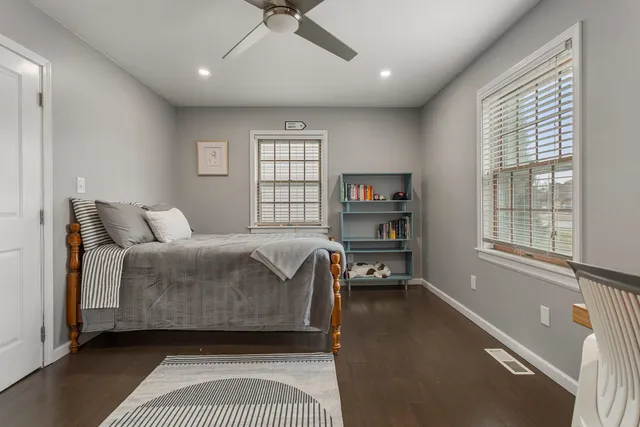 a bedroom with a bed furniture and a window