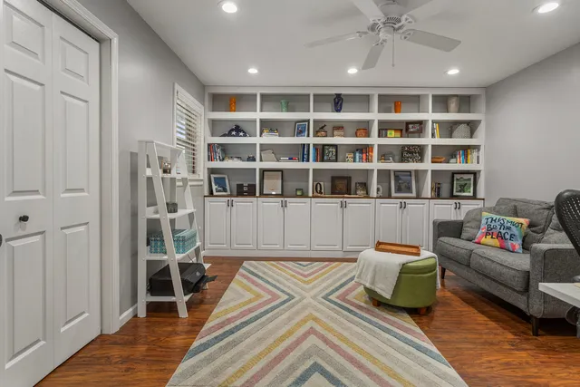 a bedroom with furniture and a book shelf