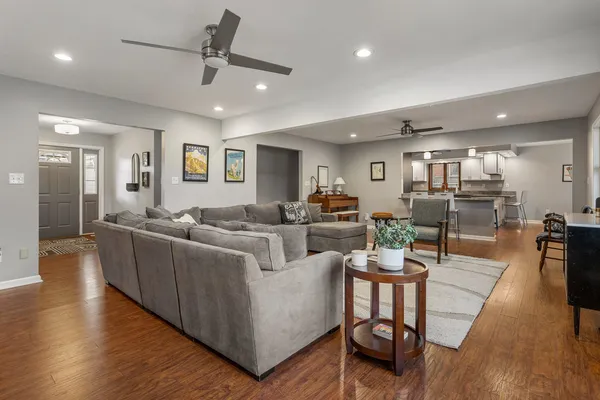 a living room with furniture and a wooden floor