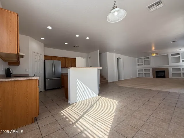 a open kitchen with cabinets and stainless steel appliances