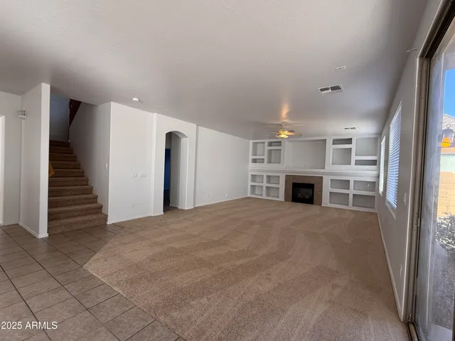 a view of an empty room with a fireplace