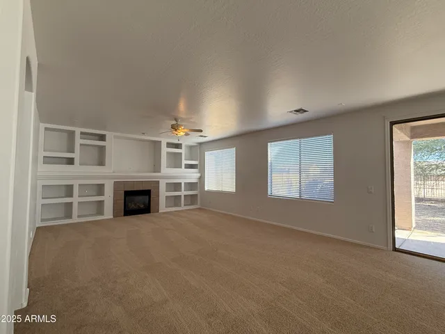 a view of an empty room with a fireplace