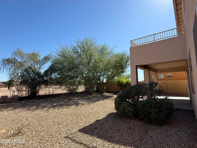 a view of a house with a cars park side of a road
