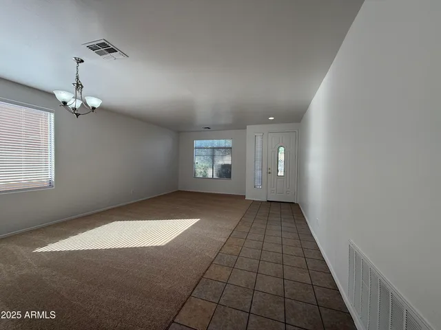 a view of an empty room and a window