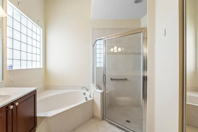 a bathroom with a bathtub shower and toilet