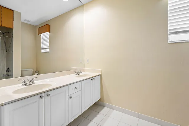 a bathroom with a double vanity sink and mirror