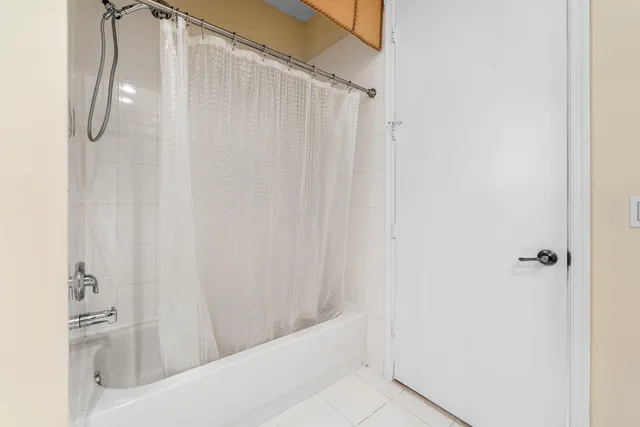 a bathroom with a shower curtain and a shower curtain