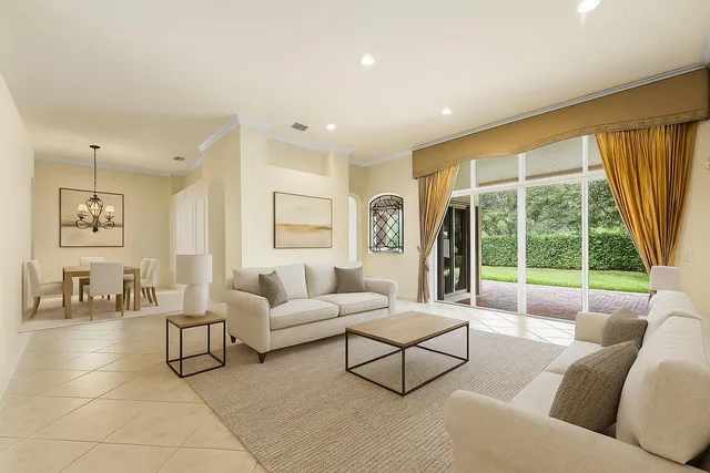 a living room with furniture and large windows