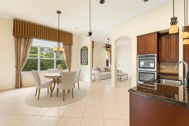 a dining room with furniture a window and kitchen view