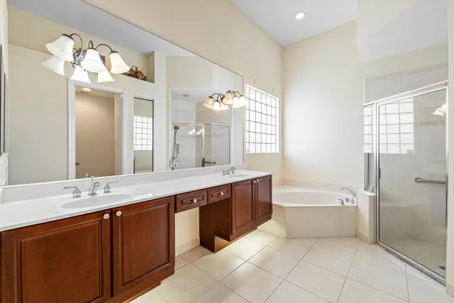 a spacious bathroom with a bathtub sink and mirror