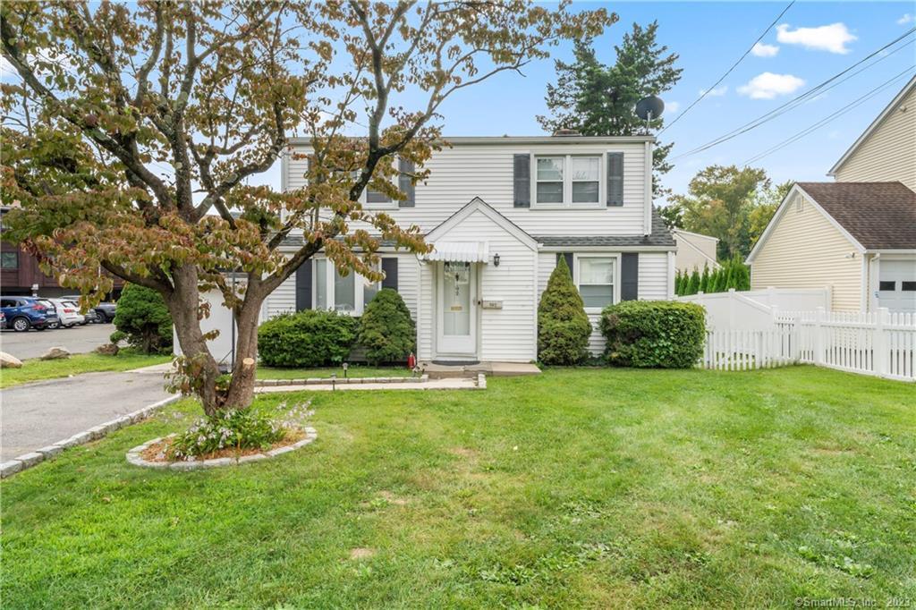 a front view of house with yard and green space