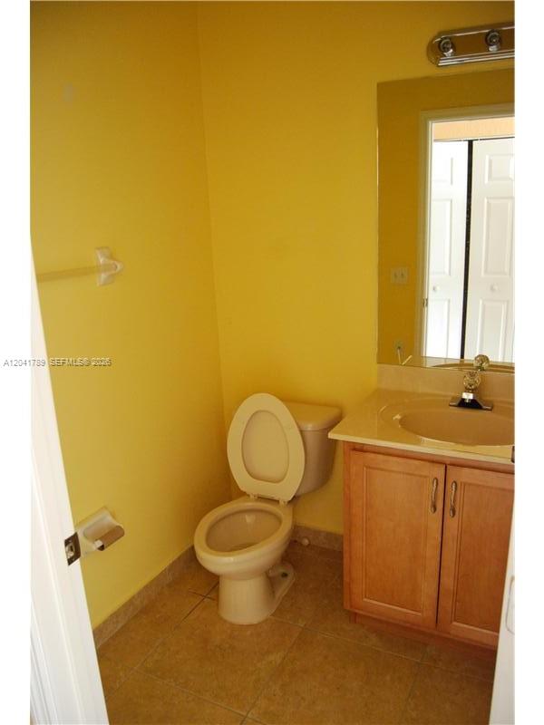 12080 Southwest 268th Street, Unit 24 Homestead, FL 33032 - Photo 7 of 29 a bathroom with a sink mirror vanity and toilet