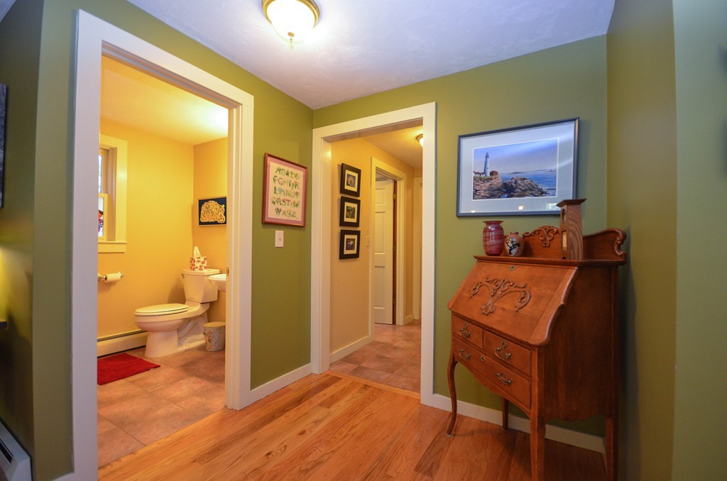 66 Barnett Road Sutton, MA 01590 - Photo 13 of 30 a view of a hallway with bathroom and wooden floor